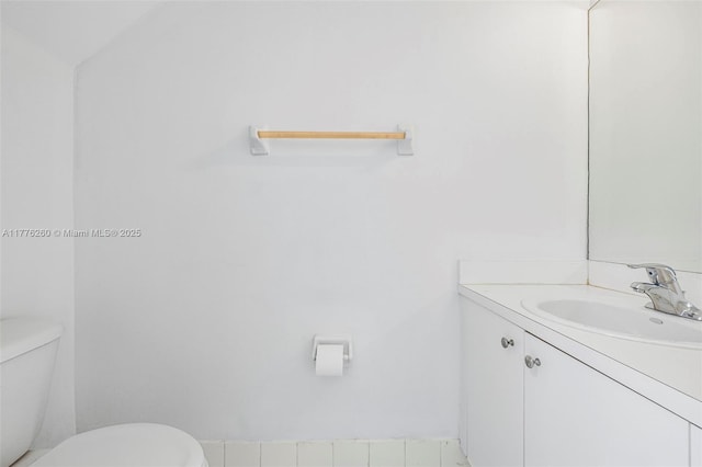 half bath featuring toilet and vanity