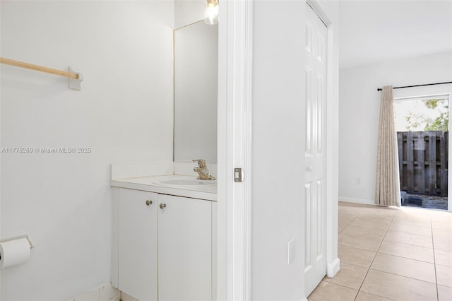 bathroom featuring baseboards, tile patterned floors, and vanity