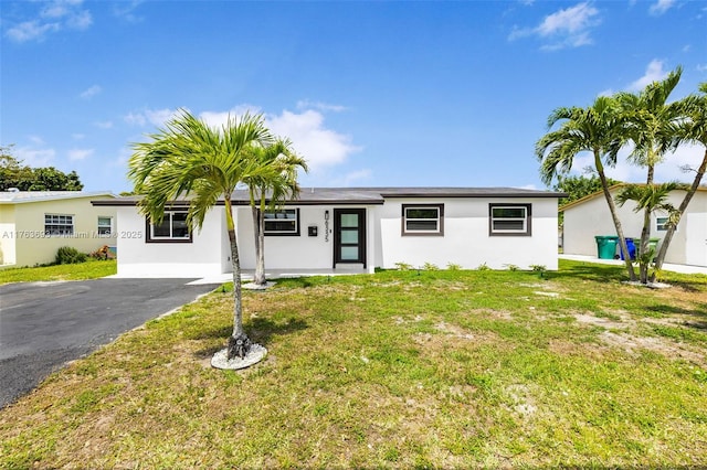 6335 Southgate Blvd, Margate, FL 33068 - ranch-style house with a front yard, stucco siding, and driveway