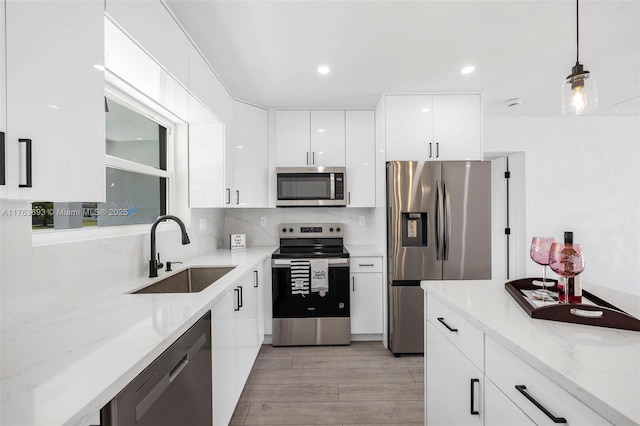 6335 Southgate Blvd, Margate, FL 33068 - kitchen featuring stainless steel appliances, a sink, modern cabinets, white cabinetry, and pendant lighting