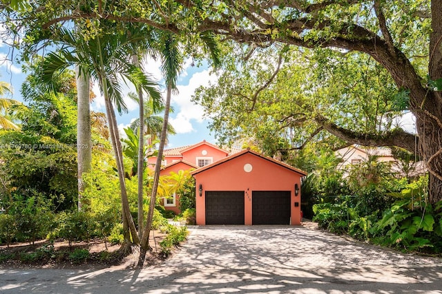 view of front of property with driveway, stucco siding, and an attached garage