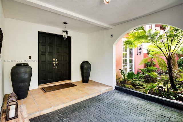 entrance to property with stucco siding and french doors