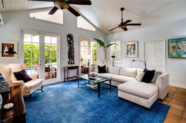 tiled living area featuring a healthy amount of sunlight, vaulted ceiling, french doors, and a ceiling fan