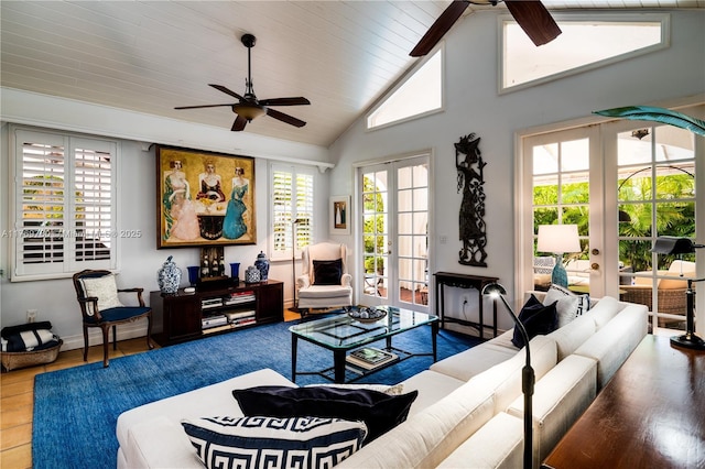 living area featuring french doors, a ceiling fan, high vaulted ceiling, and baseboards