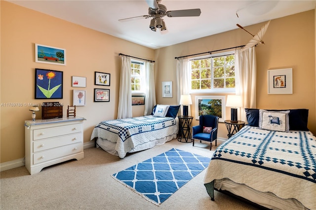 bedroom with baseboards, carpet floors, and a ceiling fan