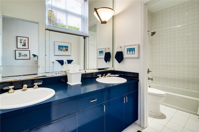 bathroom with toilet, a sink, tile patterned floors, and double vanity