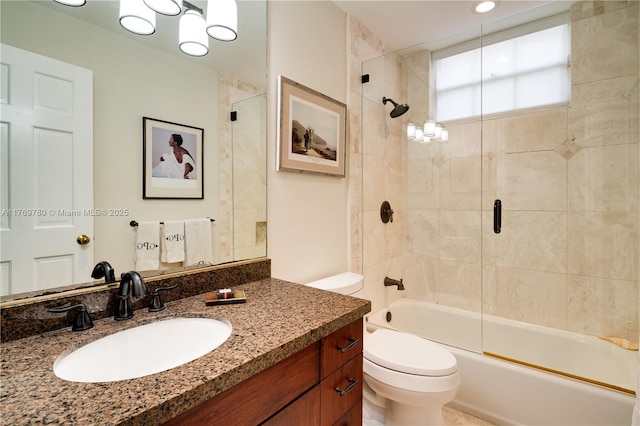 bathroom featuring bath / shower combo with glass door, toilet, and vanity