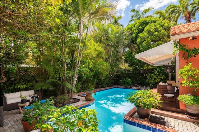 pool with fence and a patio area