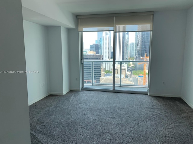 55 SE 6th St Unit 2404, Miami, FL 33131 - spare room with a city view, baseboards, and carpet floors