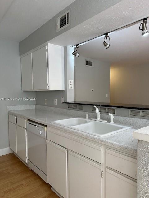 2607 NW 33rd St Unit 2111, Oakland Park, FL 33309 - kitchen with visible vents, white cabinets, a sink, and dishwasher