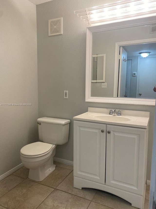 2607 NW 33rd St Unit 2111, Oakland Park, FL 33309 - half bathroom featuring baseboards, toilet, tile patterned floors, and vanity