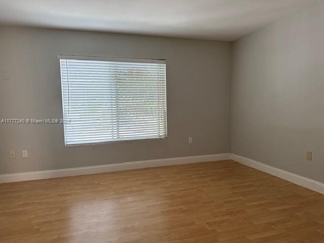 2607 NW 33rd St Unit 2111, Oakland Park, FL 33309 - empty room with baseboards and light wood-style floors