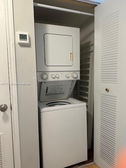 2607 NW 33rd St Unit 2111, Oakland Park, FL 33309 - laundry room featuring stacked washer and dryer and laundry area