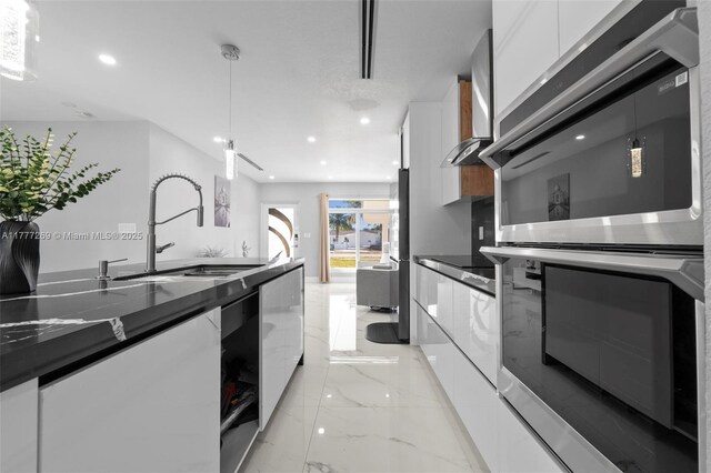 9025 SW 56th St, Miami, FL 33165 - kitchen featuring modern cabinets, white cabinetry, dark countertops, appliances with stainless steel finishes, and a sink