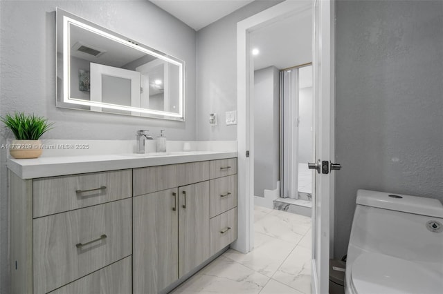 9025 SW 56th St, Miami, FL 33165 - bathroom with marble look tiles, vanity, and toilet