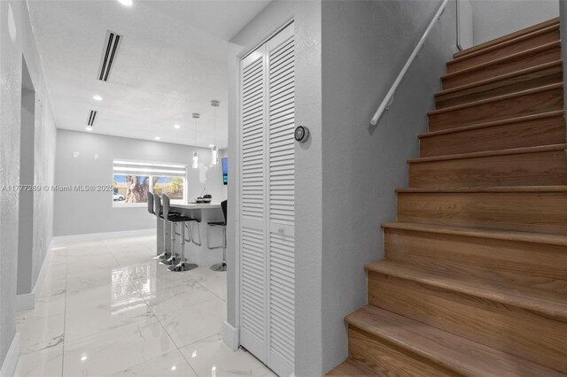 9025 SW 56th St, Miami, FL 33165 - staircase featuring marble look tile flooring and baseboards