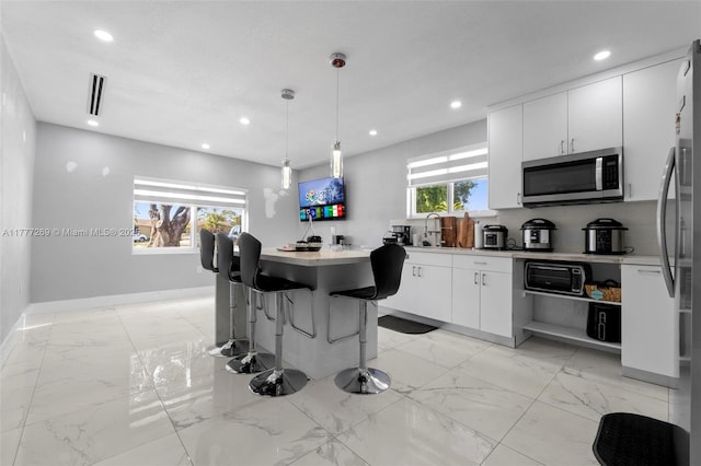 9025 SW 56th St, Miami, FL 33165 - kitchen featuring appliances with stainless steel finishes, light marble finish flooring, recessed lighting, a sink, and light countertops