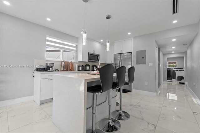 9025 SW 56th St, Miami, FL 33165 - kitchen featuring stainless steel appliances, electric panel, baseboards, white cabinets, and recessed lighting