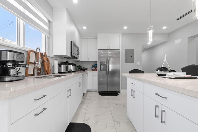 9025 SW 56th St, Miami, FL 33165 - kitchen featuring appliances with stainless steel finishes, light marble finish flooring, electric panel, a sink, and recessed lighting