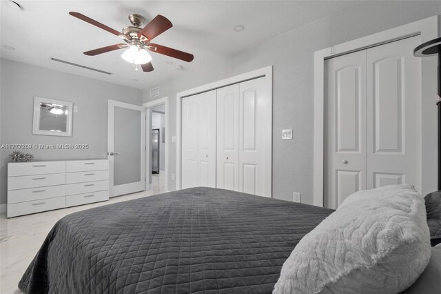 9025 SW 56th St, Miami, FL 33165 - bedroom with two closets, marble look tile flooring, and ceiling fan