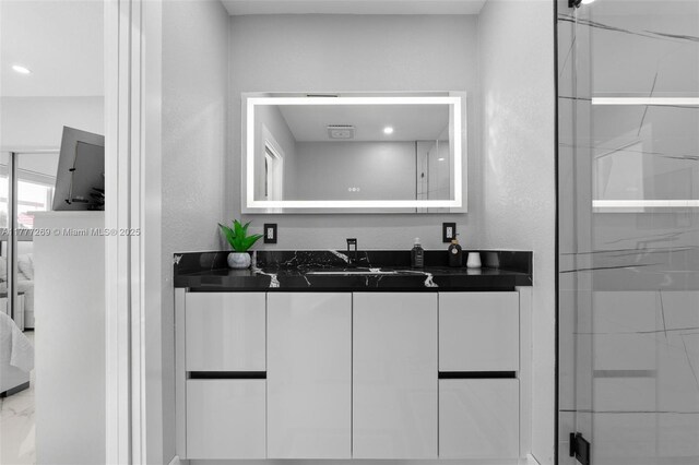 9025 SW 56th St, Miami, FL 33165 - full bathroom featuring vanity, a textured wall, a shower, and marble finish floors