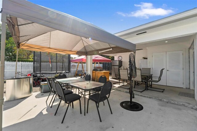 9025 SW 56th St, Miami, FL 33165 - view of patio / terrace featuring a trampoline, outdoor dining area, a gazebo, and french doors