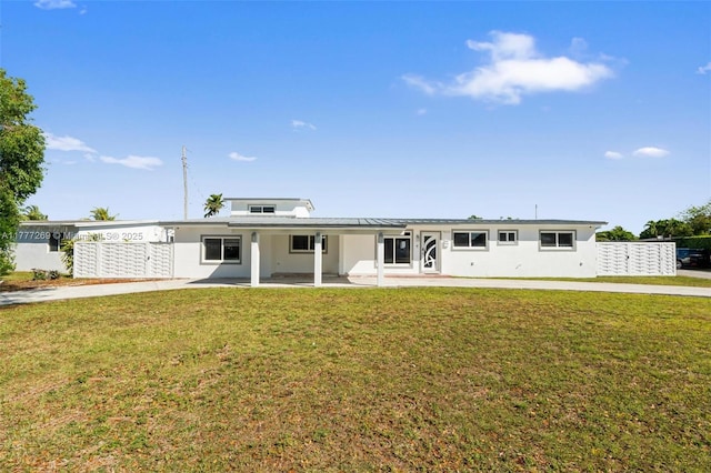 9025 SW 56th St, Miami, FL 33165 - view of front facade with stucco siding, a front lawn, and a patio