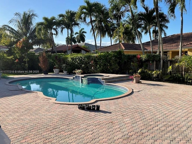 12421 SW 76th St, Miami, FL 33183 - view of pool with a pool with connected hot tub, a patio area, and fence