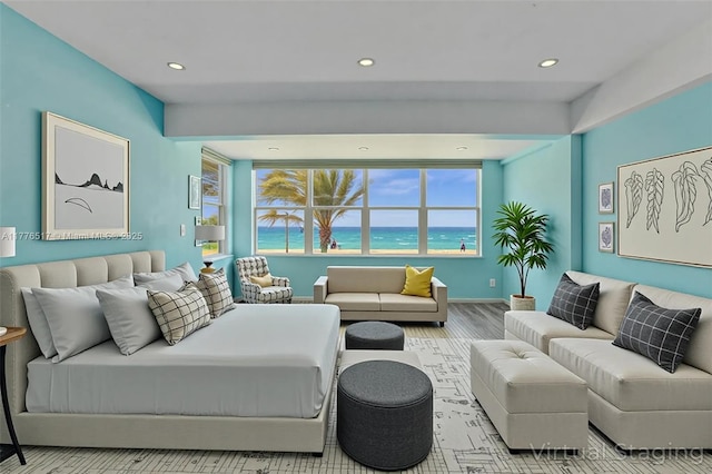 living room with baseboards, wood finished floors, recessed lighting, and a water view
