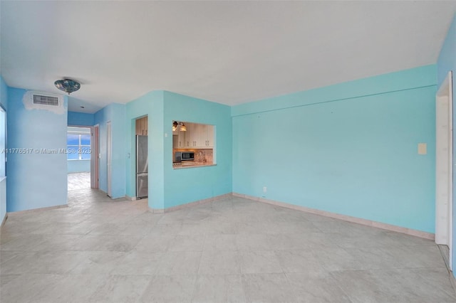 unfurnished living room featuring visible vents