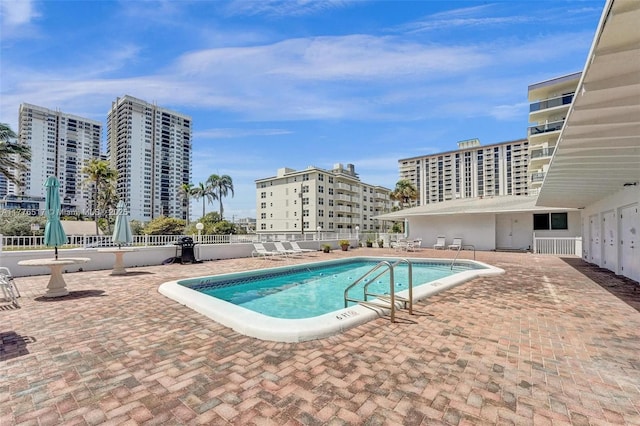 pool featuring fence and a patio