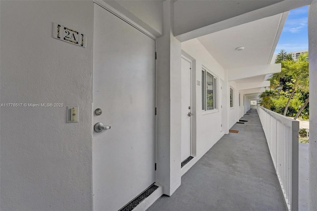 doorway to property featuring stucco siding