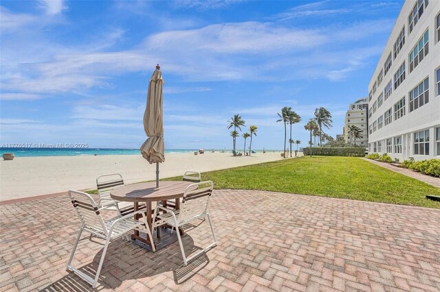 1801 S Surf Rd Unit 2A, Hollywood, FL 33019 - view of patio featuring a water view, outdoor dining space, and a view of the beach