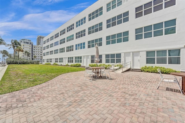 exterior space with a patio and a lawn