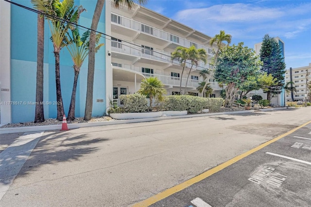 view of property featuring uncovered parking