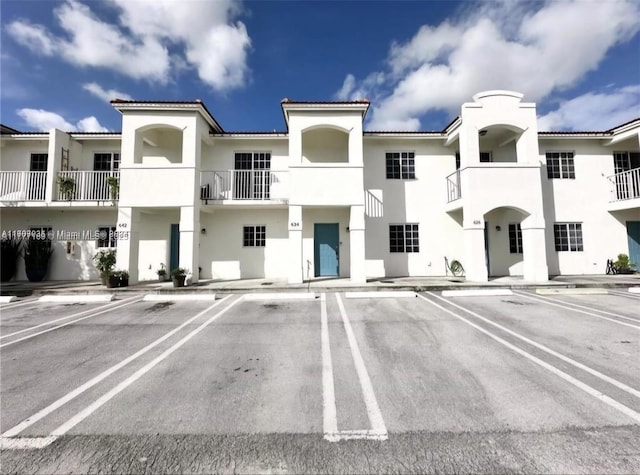 view of property featuring uncovered parking