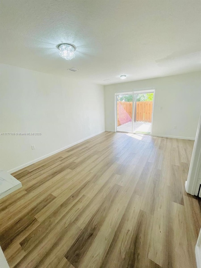 unfurnished room featuring light wood-style flooring and baseboards