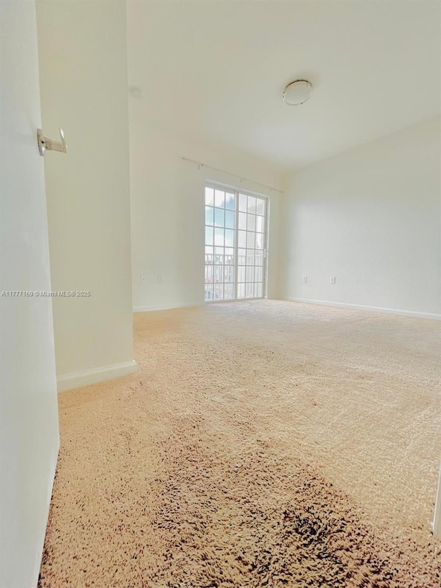 spare room featuring baseboards