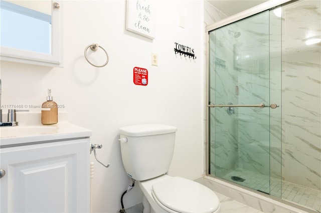 full bath with toilet, vanity, and a marble finish shower