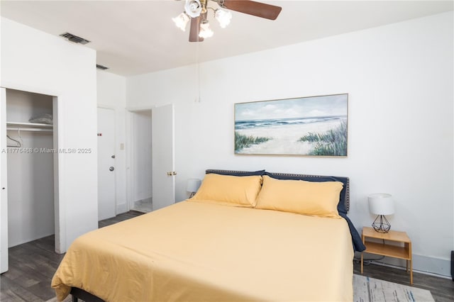 bedroom with wood finished floors, ceiling fan, a closet, and visible vents