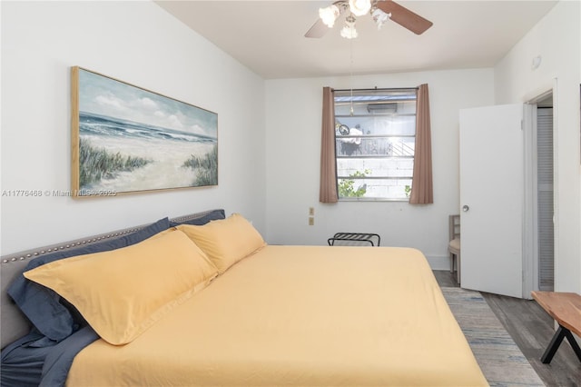 bedroom with a ceiling fan and wood finished floors
