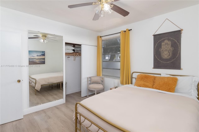 bedroom with wood finished floors, a closet, and a ceiling fan