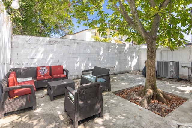 view of patio / terrace with a fenced backyard, cooling unit, and an outdoor hangout area