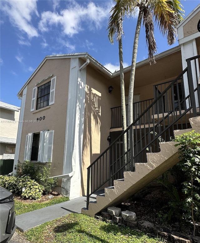 900 Constitution Dr Unit 900L, Homestead, FL 33034 - view of side of property with stairs and stucco siding