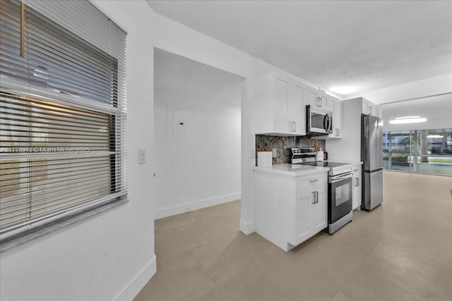 650 SW 124th Ter Unit 105P, Pembroke Pines, FL 33027 - kitchen featuring appliances with stainless steel finishes, white cabinets, and baseboards