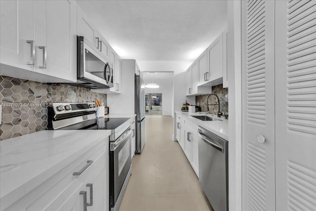 650 SW 124th Ter Unit 105P, Pembroke Pines, FL 33027 - kitchen with appliances with stainless steel finishes, a sink, light countertops, and tasteful backsplash