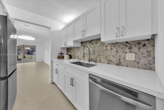 650 SW 124th Ter Unit 105P, Pembroke Pines, FL 33027 - kitchen with stainless steel appliances, a sink, light countertops, decorative backsplash, and white cabinets