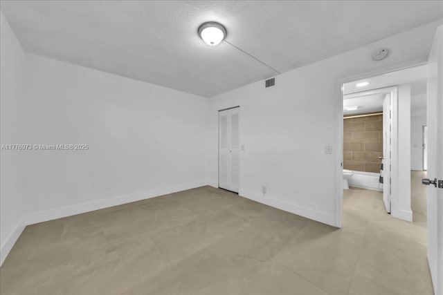 650 SW 124th Ter Unit 105P, Pembroke Pines, FL 33027 - unfurnished bedroom with a closet, baseboards, and tile patterned flooring