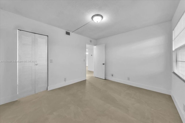650 SW 124th Ter Unit 105P, Pembroke Pines, FL 33027 - unfurnished bedroom with baseboards, a closet, and multiple windows