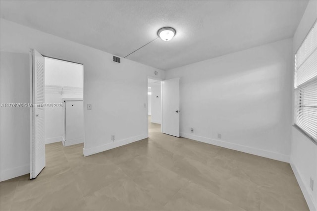 650 SW 124th Ter Unit 105P, Pembroke Pines, FL 33027 - unfurnished bedroom with baseboards, a closet, and a walk in closet